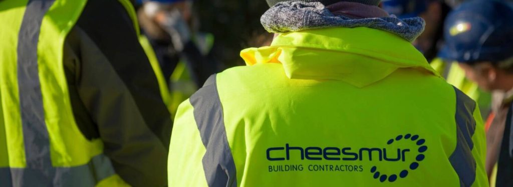 Image shows a high vis jacket with the Cheesmur Building Contractors logo on it