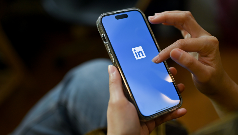 Somebody using LinkedIn on their mobile phone